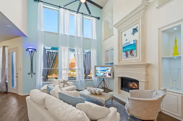 a living room with furniture a fireplace and a window
