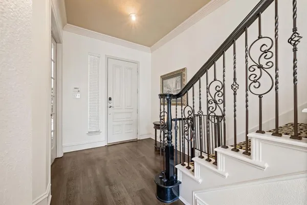 a view of entryway and hall with wooden floor