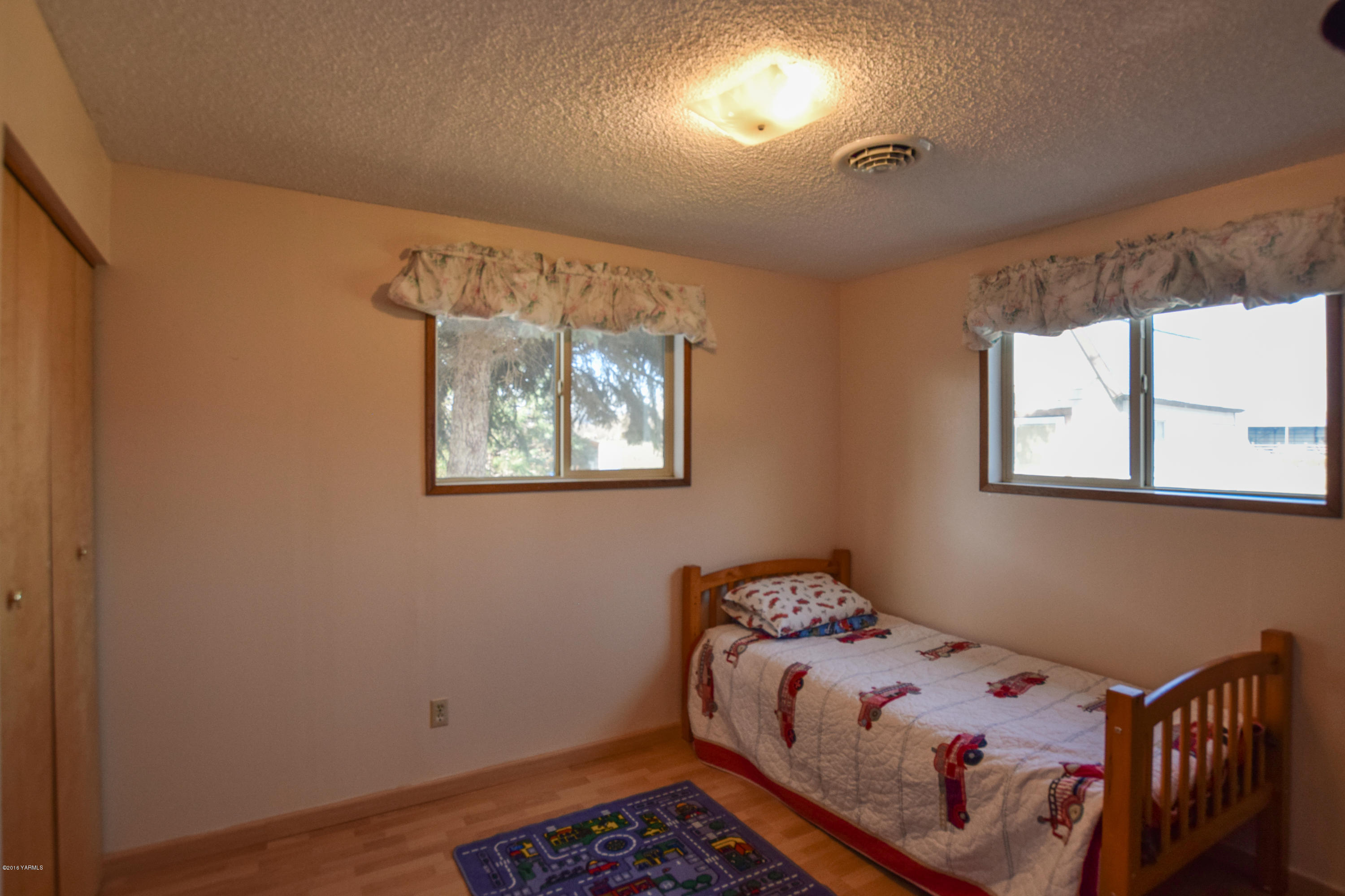 12301 Rutherford Road Yakima, WA 98903 - Photo 13 of 34 a bedroom with a bed and wooden floor