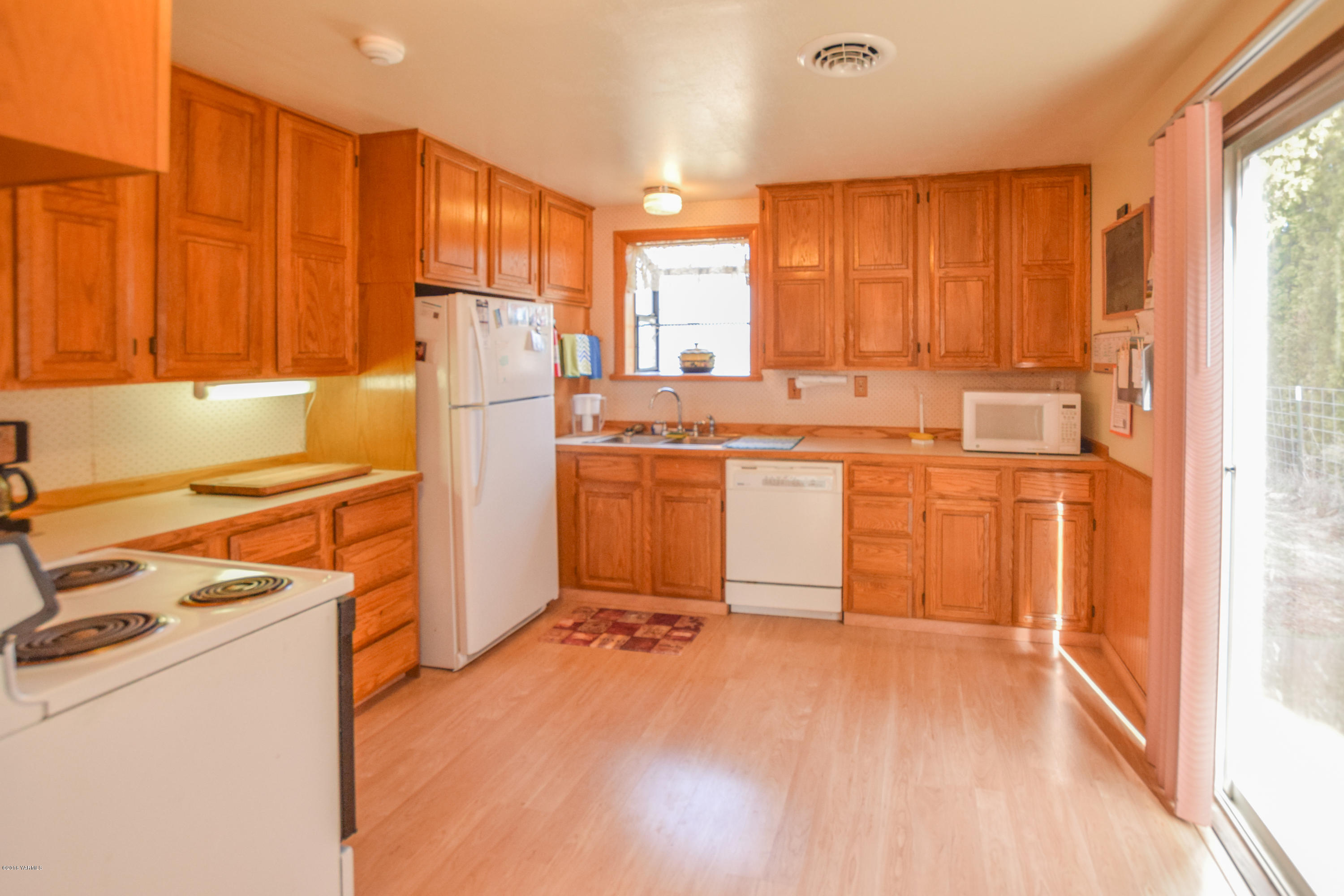 12301 Rutherford Road Yakima, WA 98903 - Photo 4 of 34 a kitchen with a sink a stove and cabinets