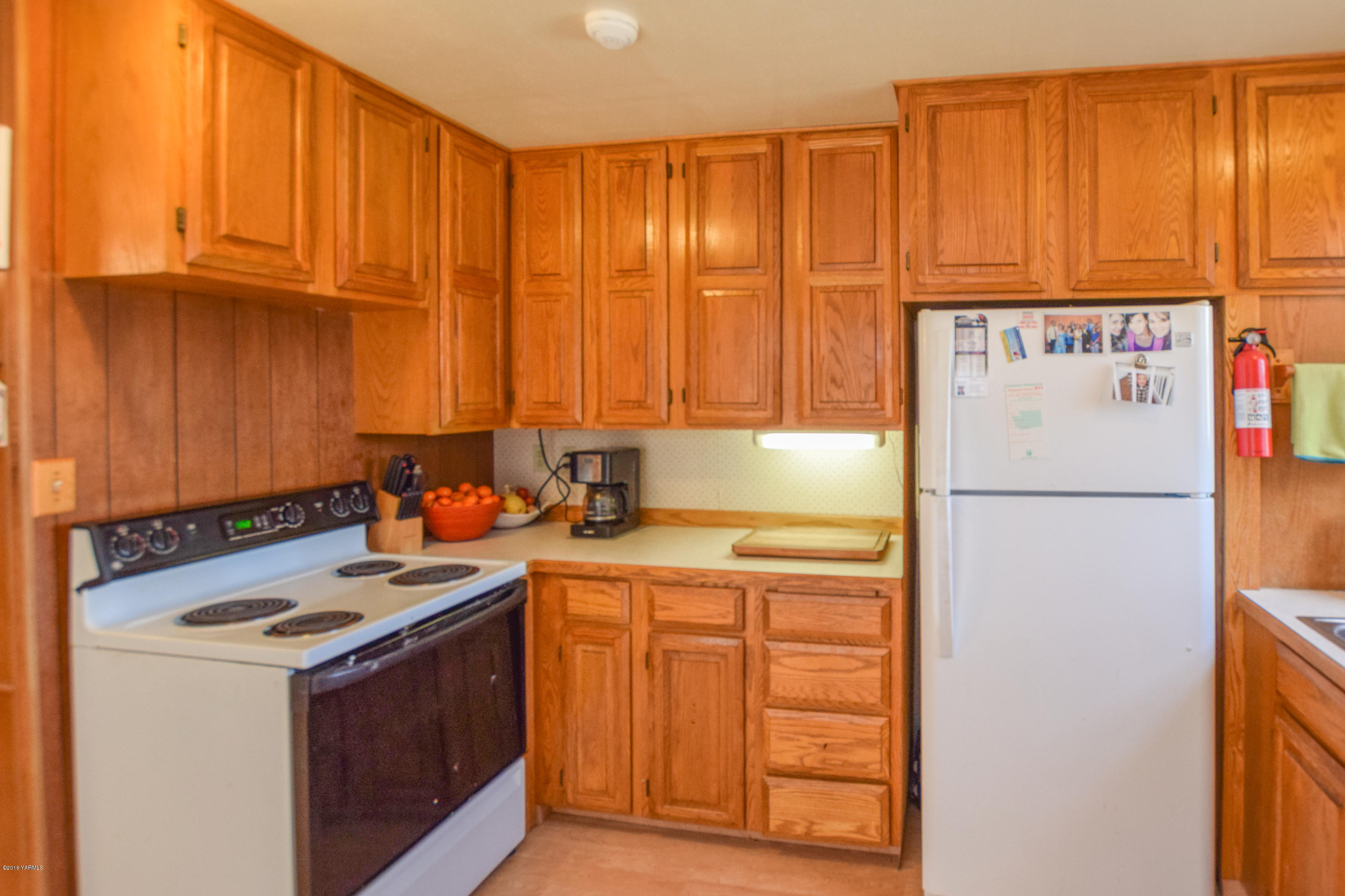 12301 Rutherford Road Yakima, WA 98903 - Photo 5 of 34 a kitchen with a refrigerator sink and cabinets