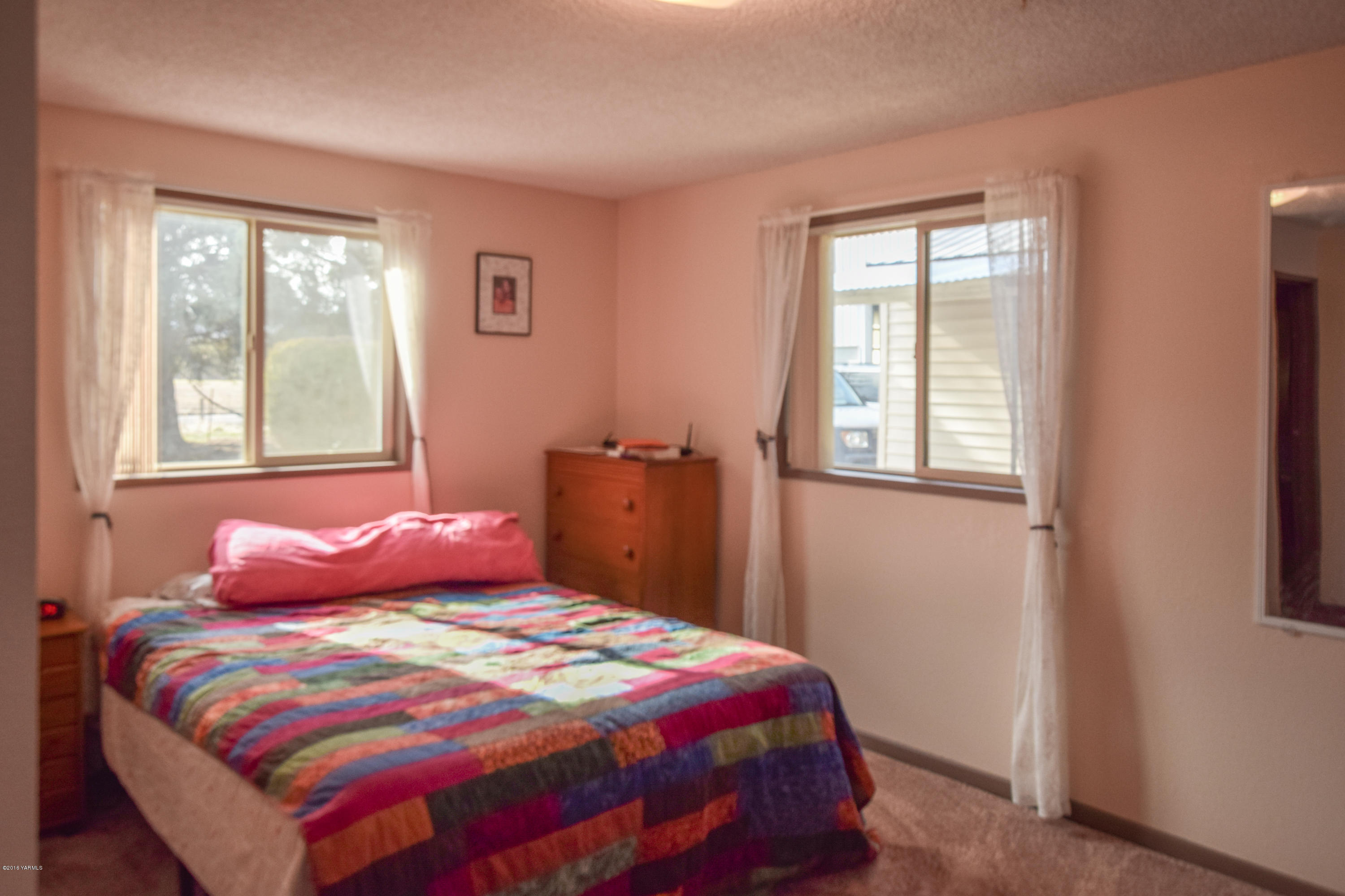 12301 Rutherford Road Yakima, WA 98903 - Photo 8 of 34 a bedroom with a bed and wooden floor