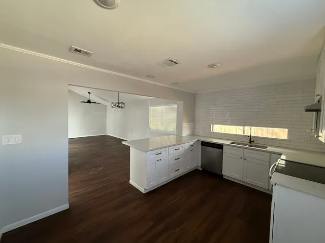 a view of kitchen and hall with wooden floor