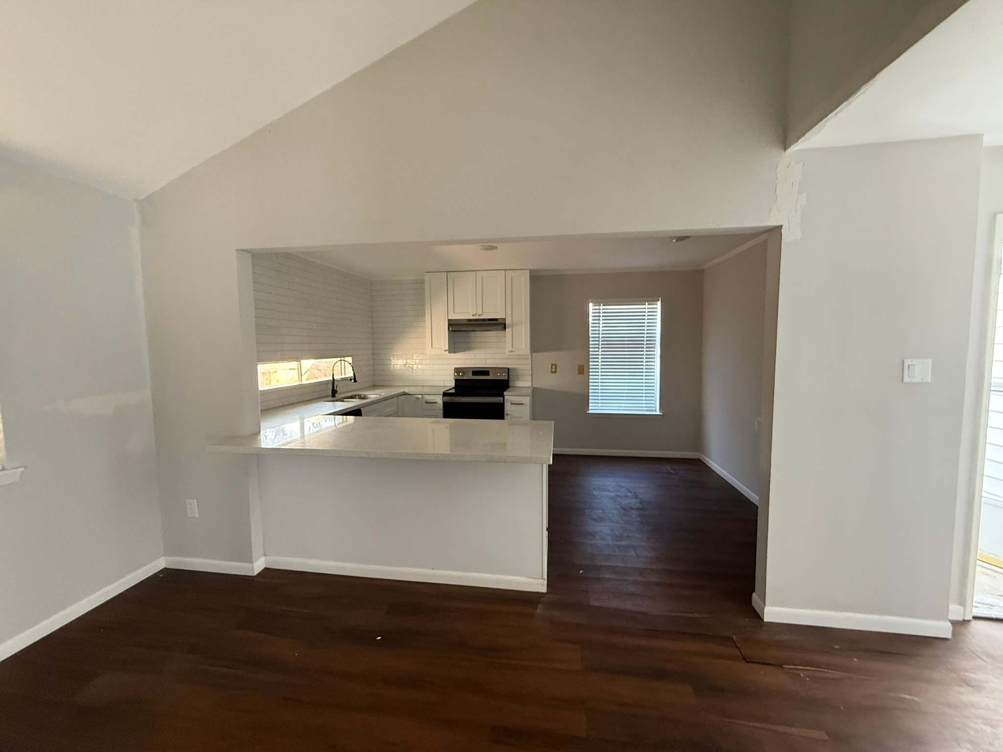 7807 Secretariat Lane Houston, TX 77071 - Photo 3 of 15 a view of kitchen and hall with wooden floor