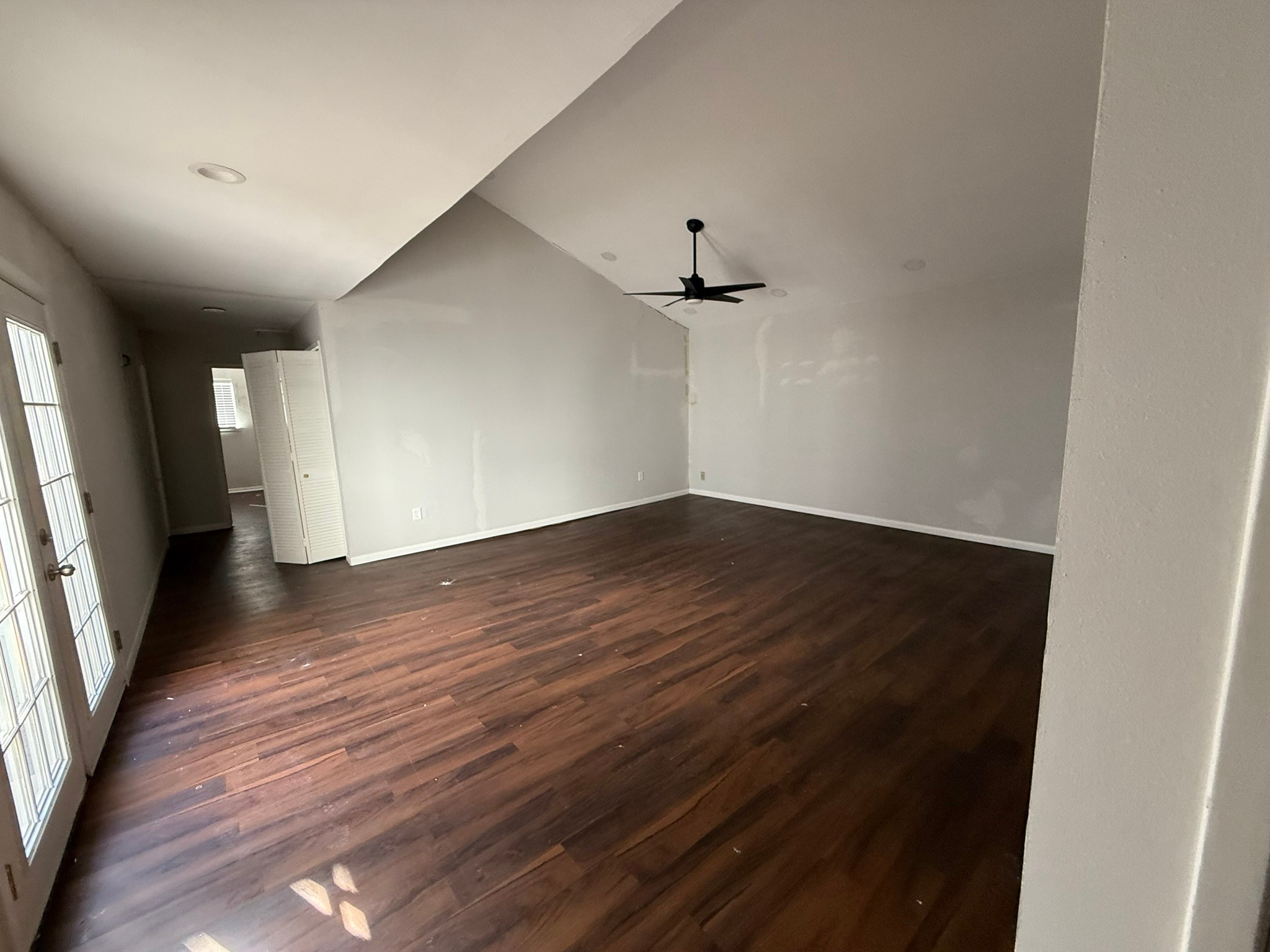 7807 Secretariat Lane Houston, TX 77071 - Photo 5 of 15 an empty room with wooden floor and windows