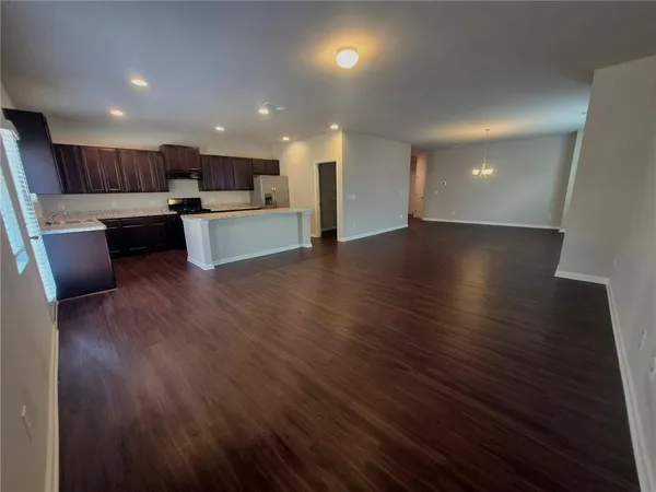 a view of kitchen with microwave and cabinets