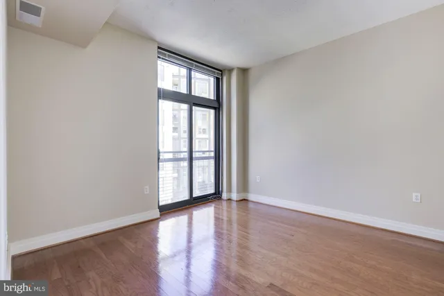 wooden floor in an empty room with a window