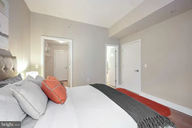 a bedroom with a bed and a lamp