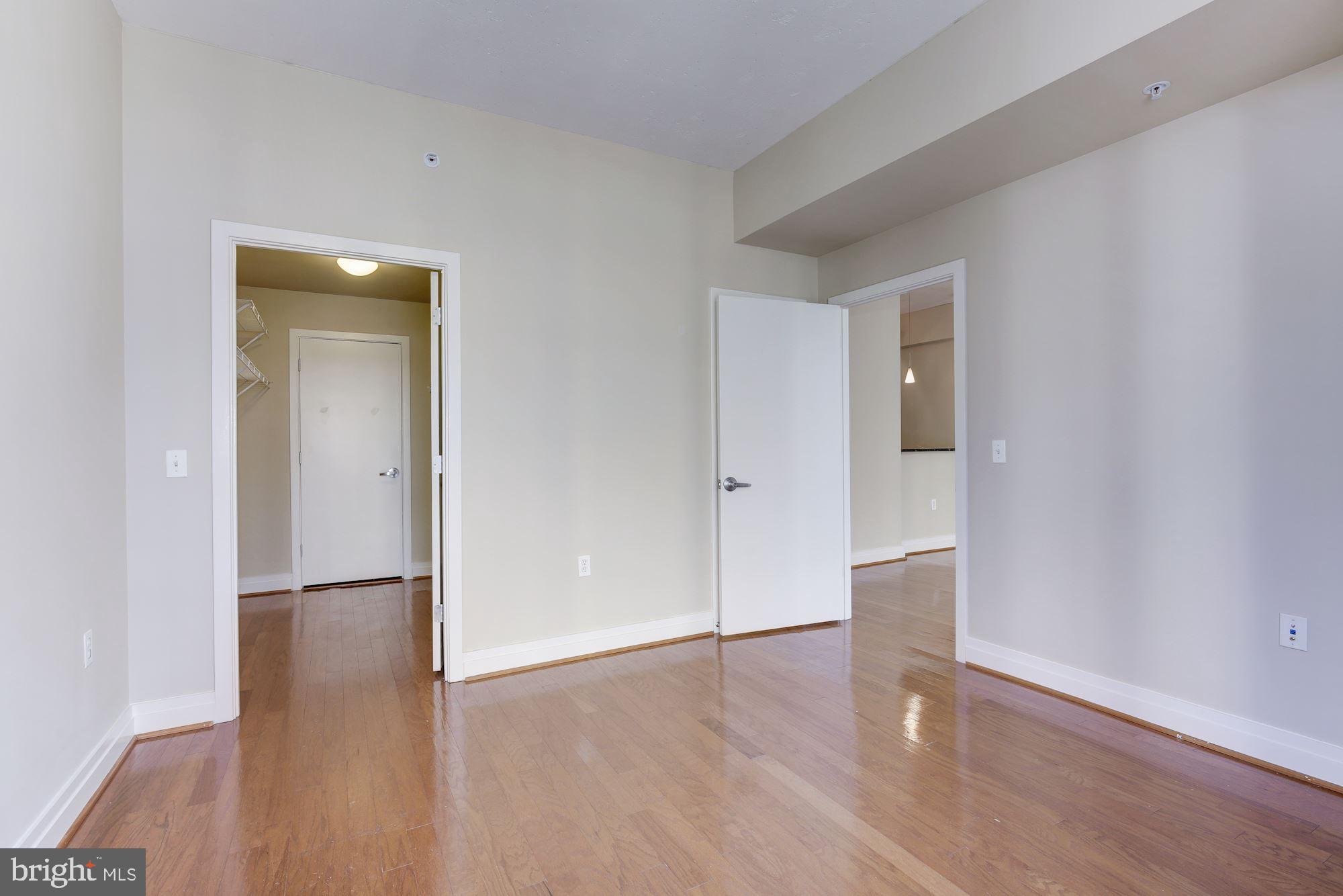 2120 Vermont Avenue Northwest, Unit 402 Washington, DC 20001 - Photo 25 of 41 a view of an empty room with wooden floor and a bathroom