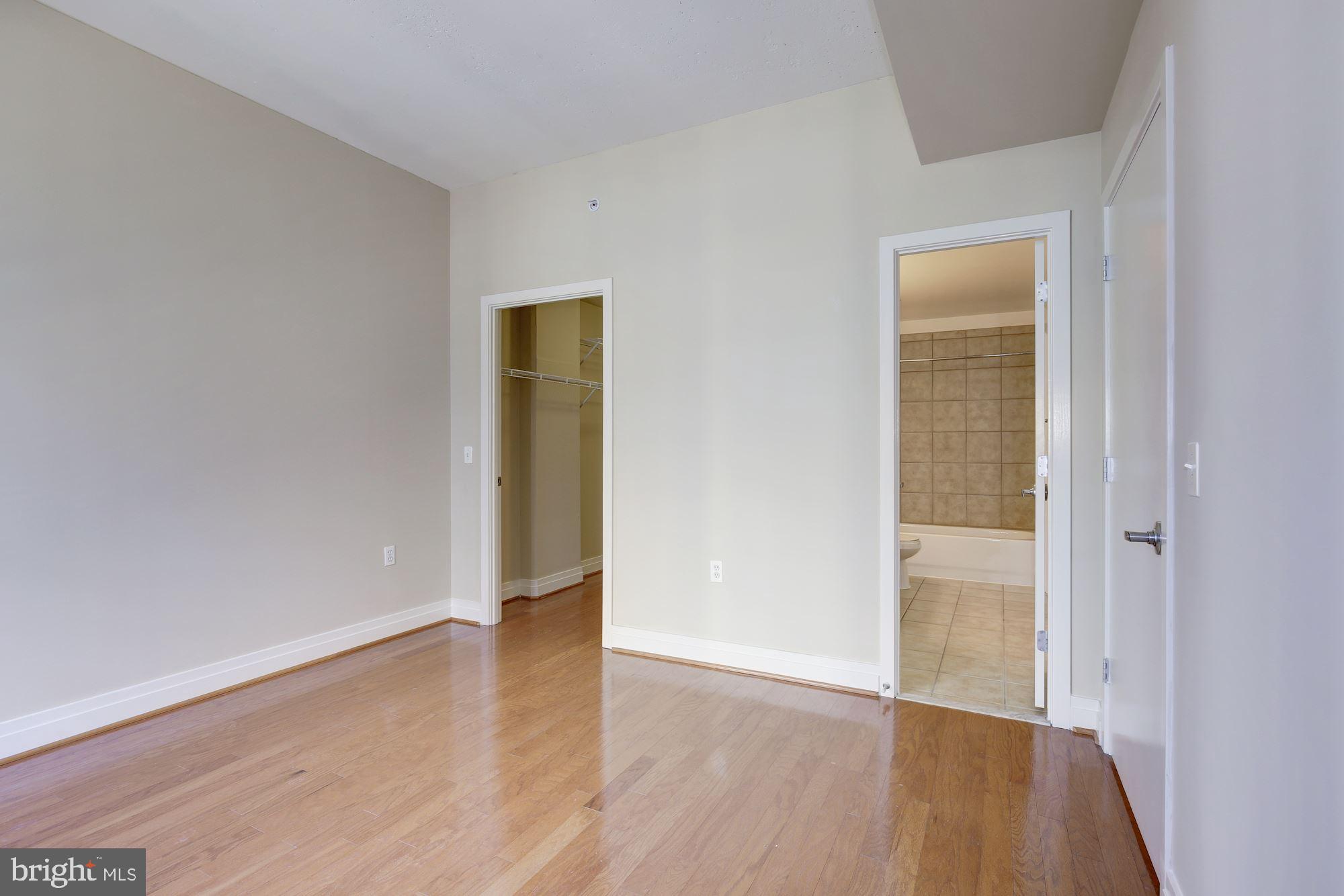 2120 Vermont Avenue Northwest, Unit 402 Washington, DC 20001 - Photo 26 of 41 an empty room with wooden floor and closet