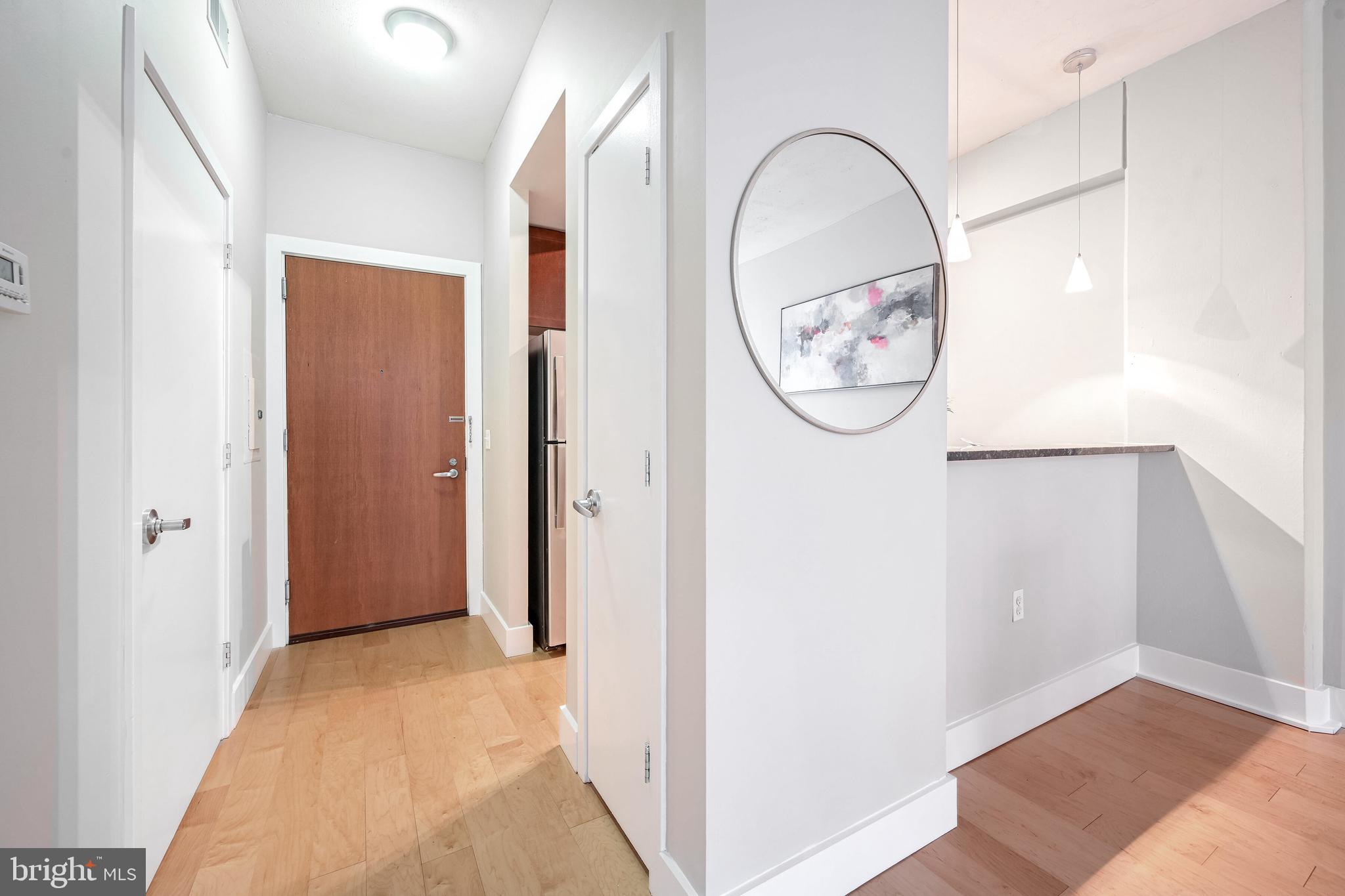 2120 Vermont Avenue Northwest, Unit 402 Washington, DC 20001 - Photo 3 of 41 a view of a livingroom with wooden floor and white walls