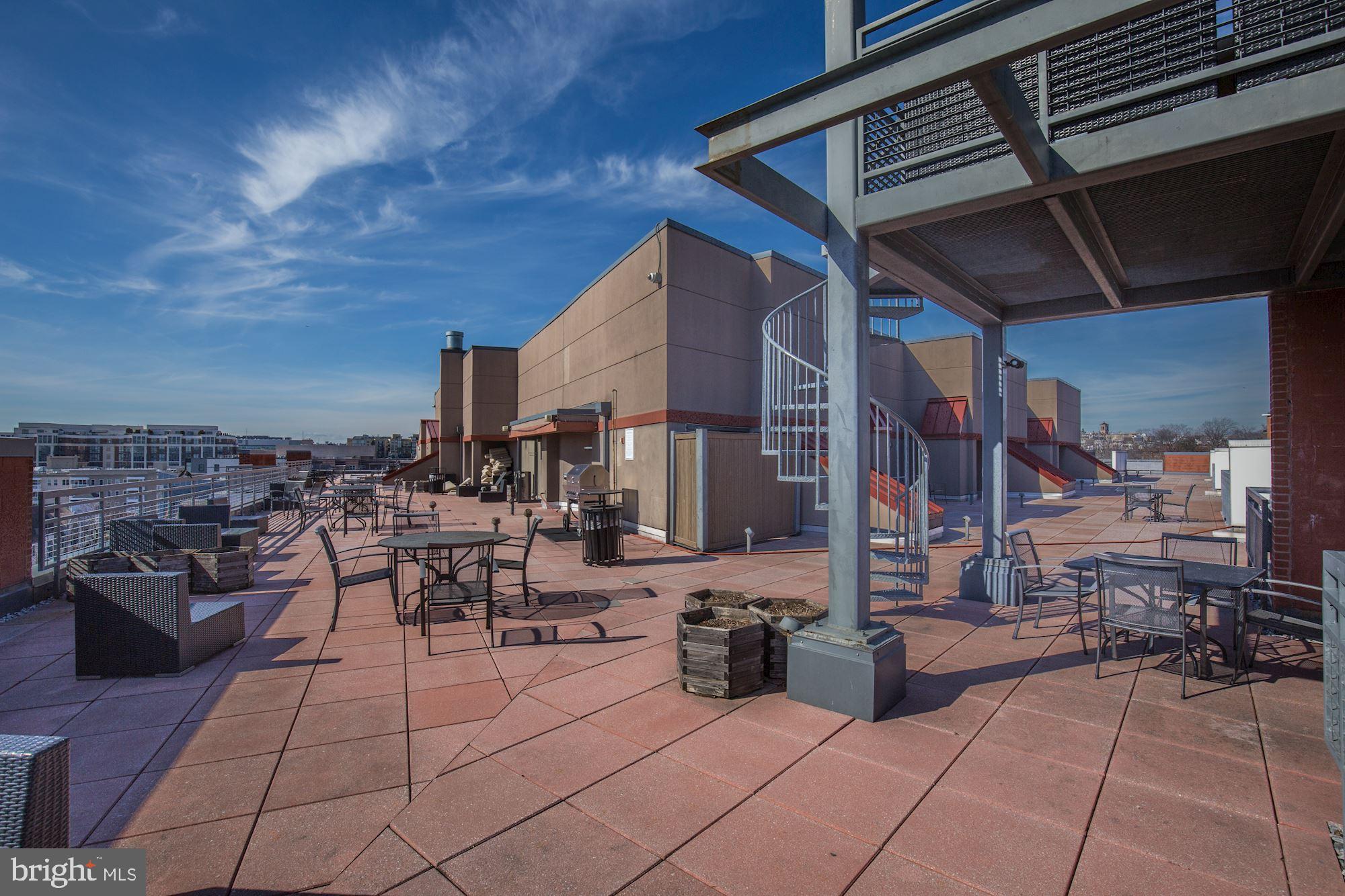 2120 Vermont Avenue Northwest, Unit 402 Washington, DC 20001 - Photo 36 of 41 a view of a patio with dining table and chairs with a barbeque grill and plants