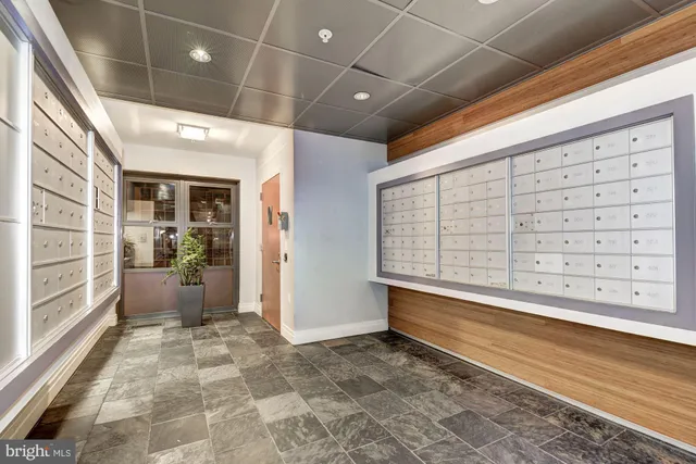 a living room with furniture a rug and white walls