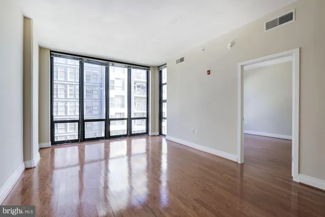 wooden floor in an empty room with a window