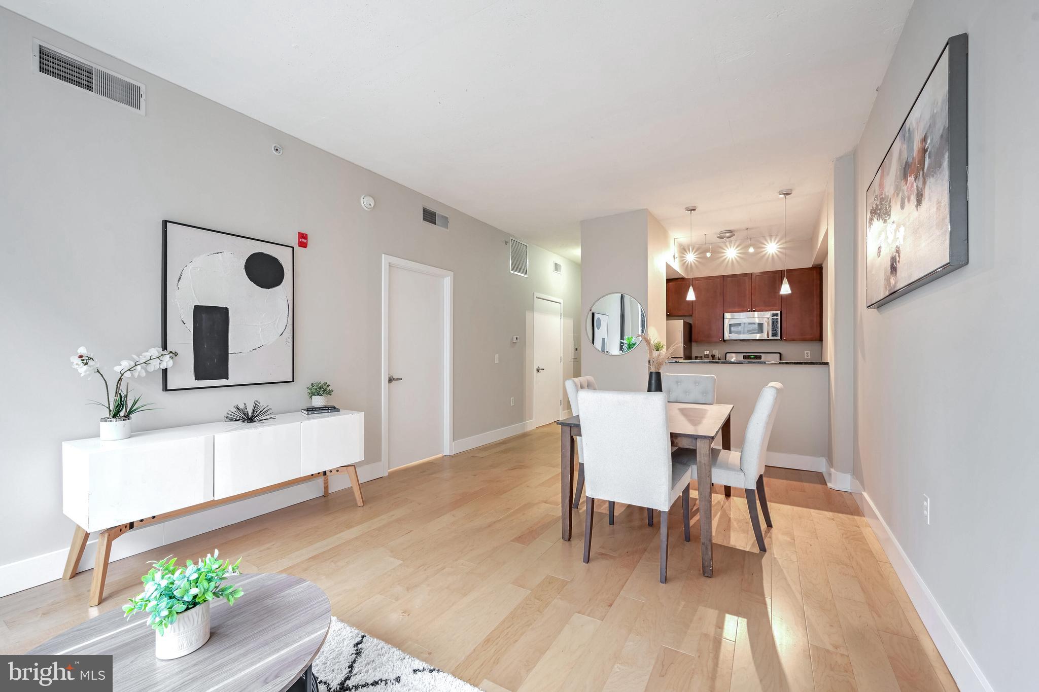 2120 Vermont Avenue Northwest, Unit 402 Washington, DC 20001 - Photo 10 of 41 a dining room with wooden floor and a chandelier
