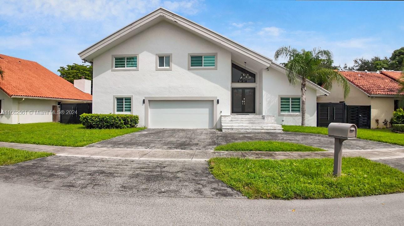 13505 Southwest 119th Street Miami, FL 33186 - Photo 1 of 25 a front view of house with yard and green space