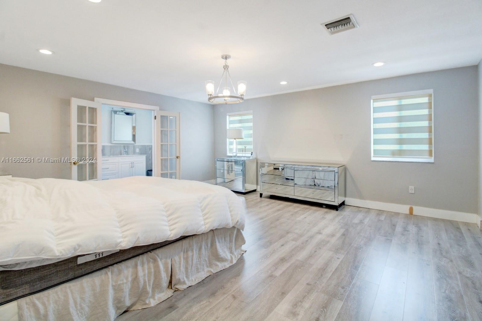 13505 Southwest 119th Street Miami, FL 33186 - Photo 14 of 25 a spacious bedroom with a bed and a large window
