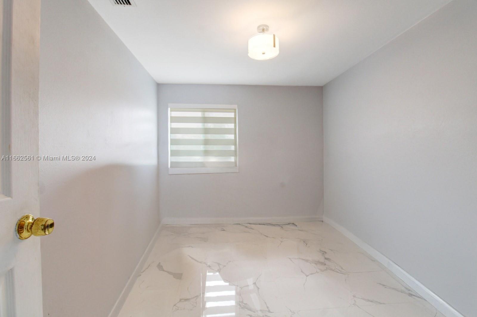 13505 Southwest 119th Street Miami, FL 33186 - Photo 16 of 25 an empty room with a window