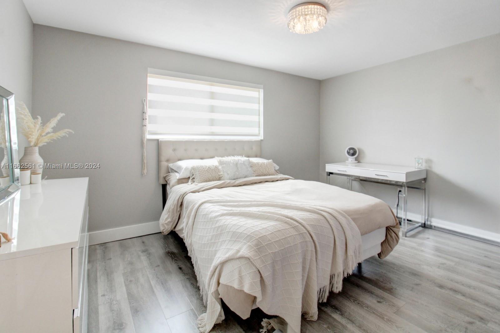 13505 Southwest 119th Street Miami, FL 33186 - Photo 20 of 25 a bedroom with a bed and a window