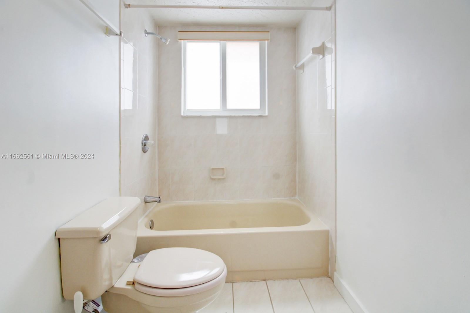 13505 Southwest 119th Street Miami, FL 33186 - Photo 22 of 25 a white bath tub sitting next to a toilet