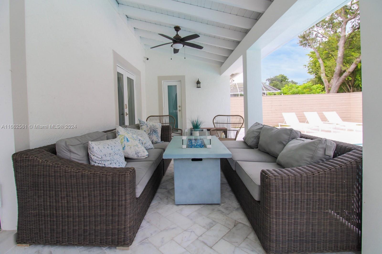 13505 Southwest 119th Street Miami, FL 33186 - Photo 23 of 25 a living room with furniture and a large window