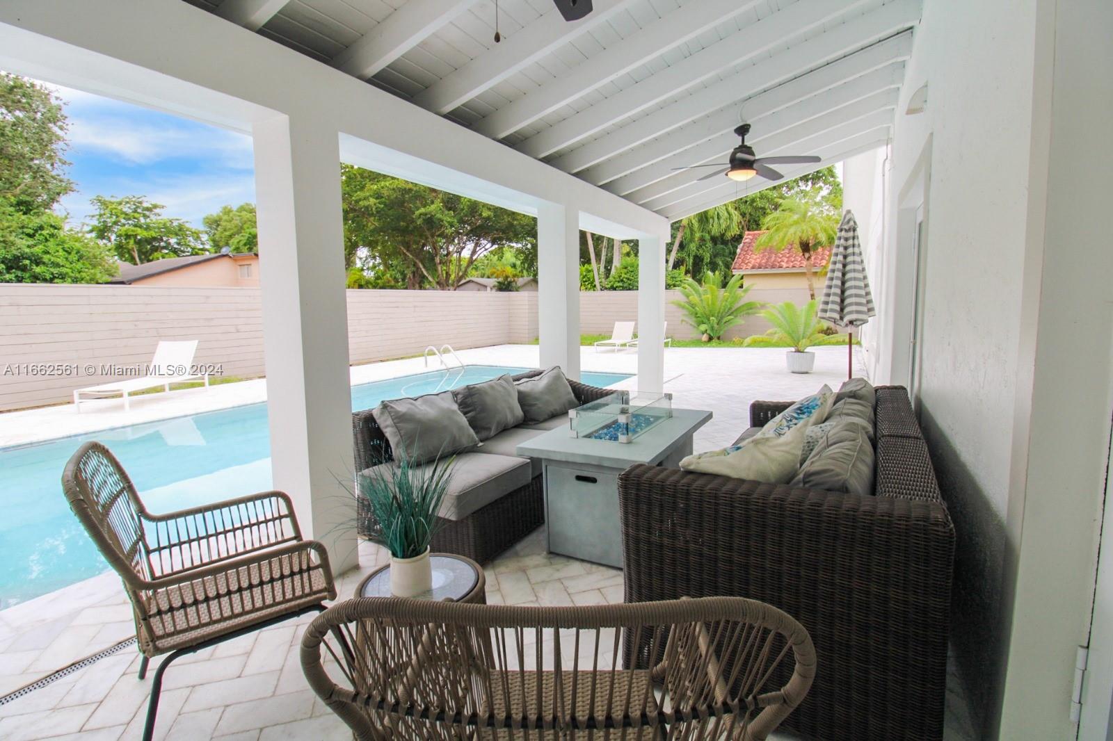 13505 Southwest 119th Street Miami, FL 33186 - Photo 24 of 25 a living room with furniture and a large window