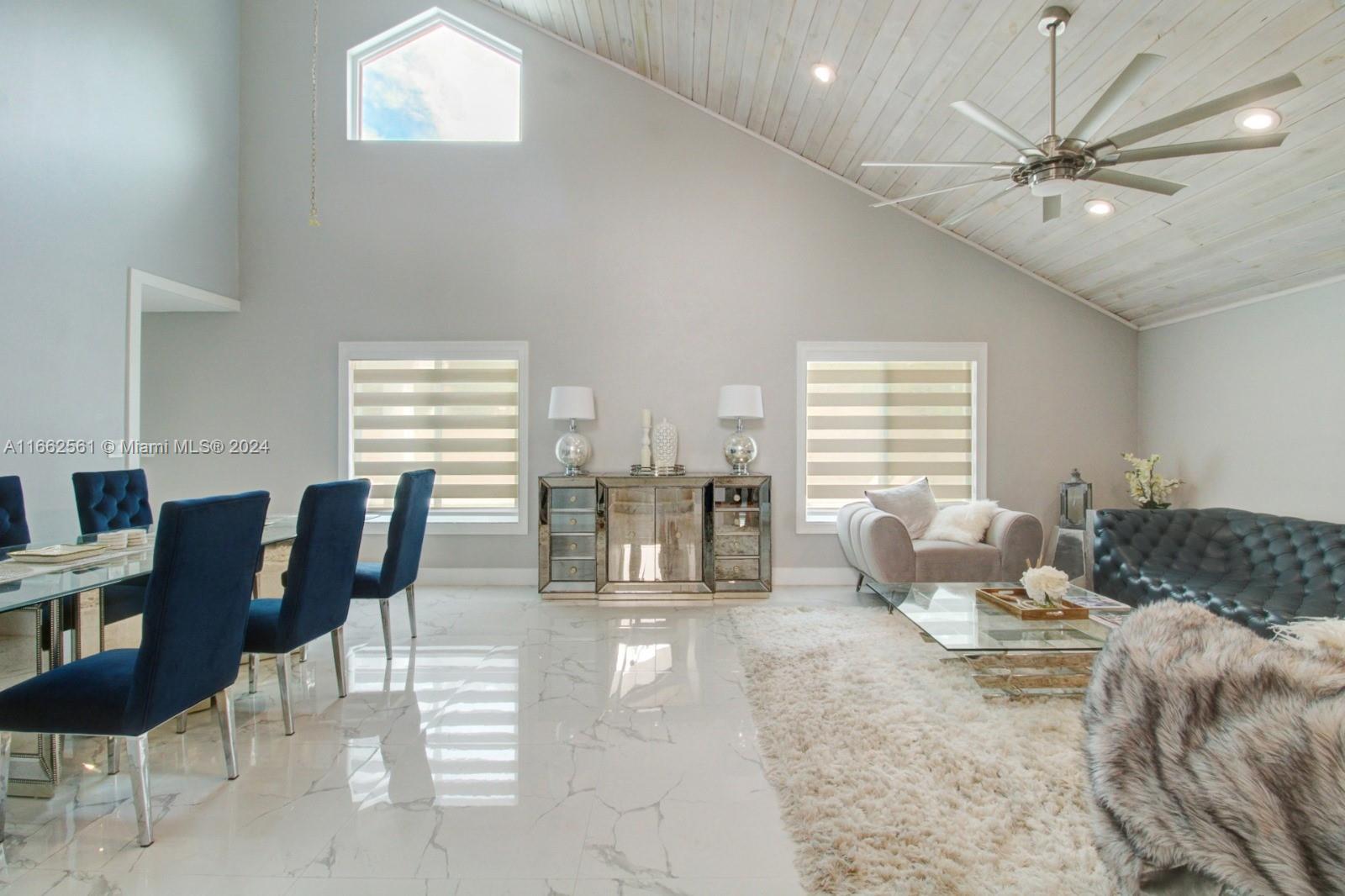 13505 Southwest 119th Street Miami, FL 33186 - Photo 4 of 25 a living room with furniture and white walls