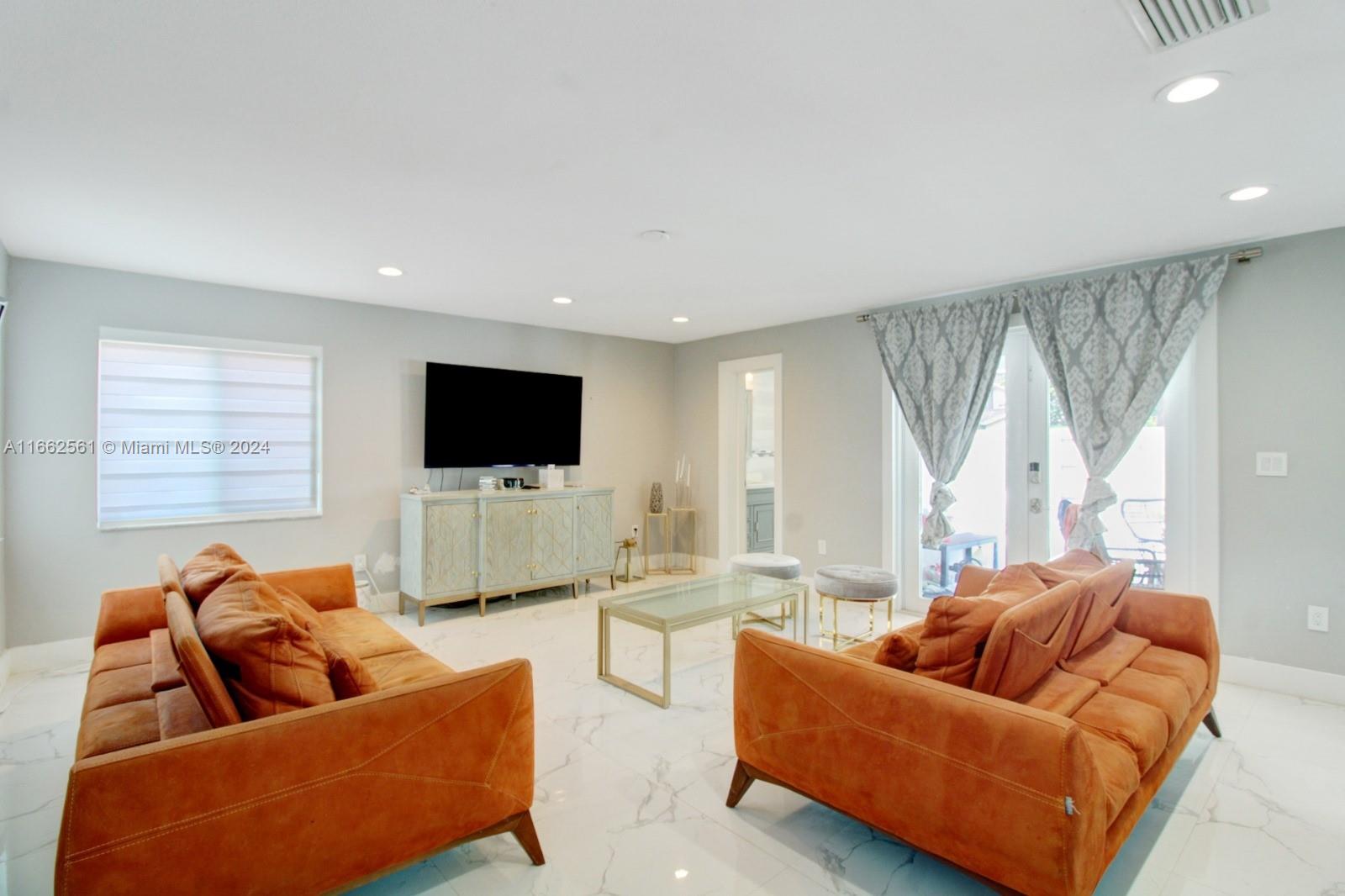 13505 Southwest 119th Street Miami, FL 33186 - Photo 6 of 25 a living room with furniture and a flat screen tv