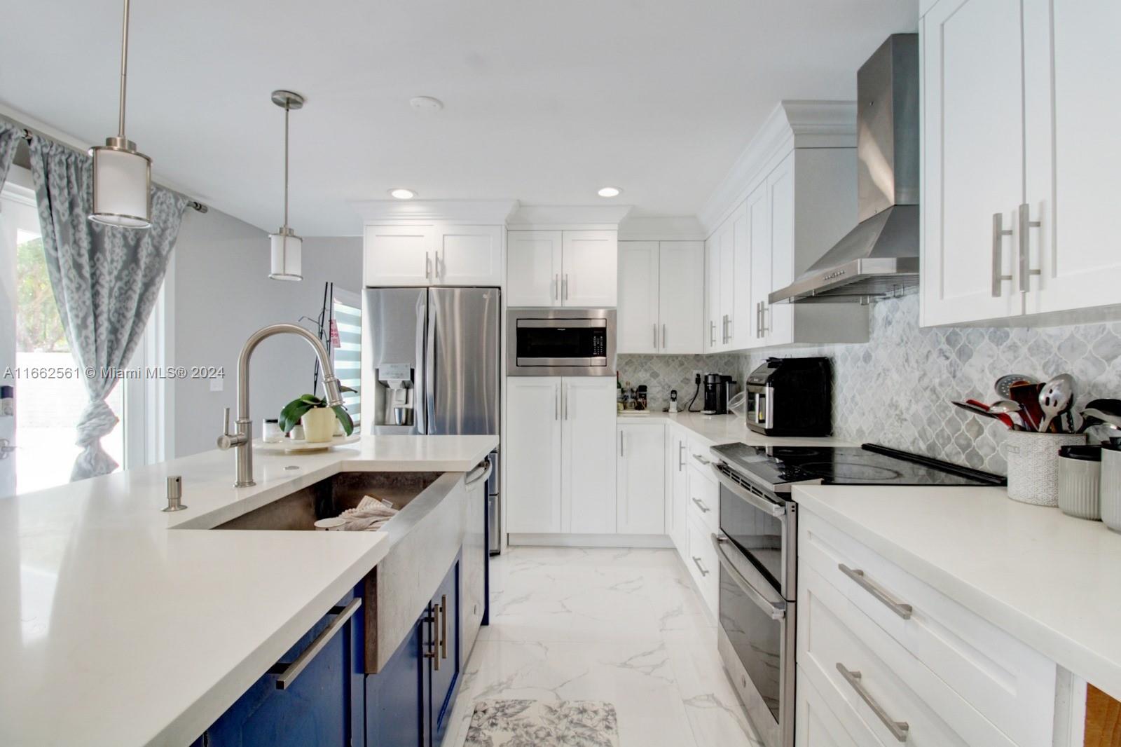 13505 Southwest 119th Street Miami, FL 33186 - Photo 9 of 25 a kitchen with white cabinets and appliances