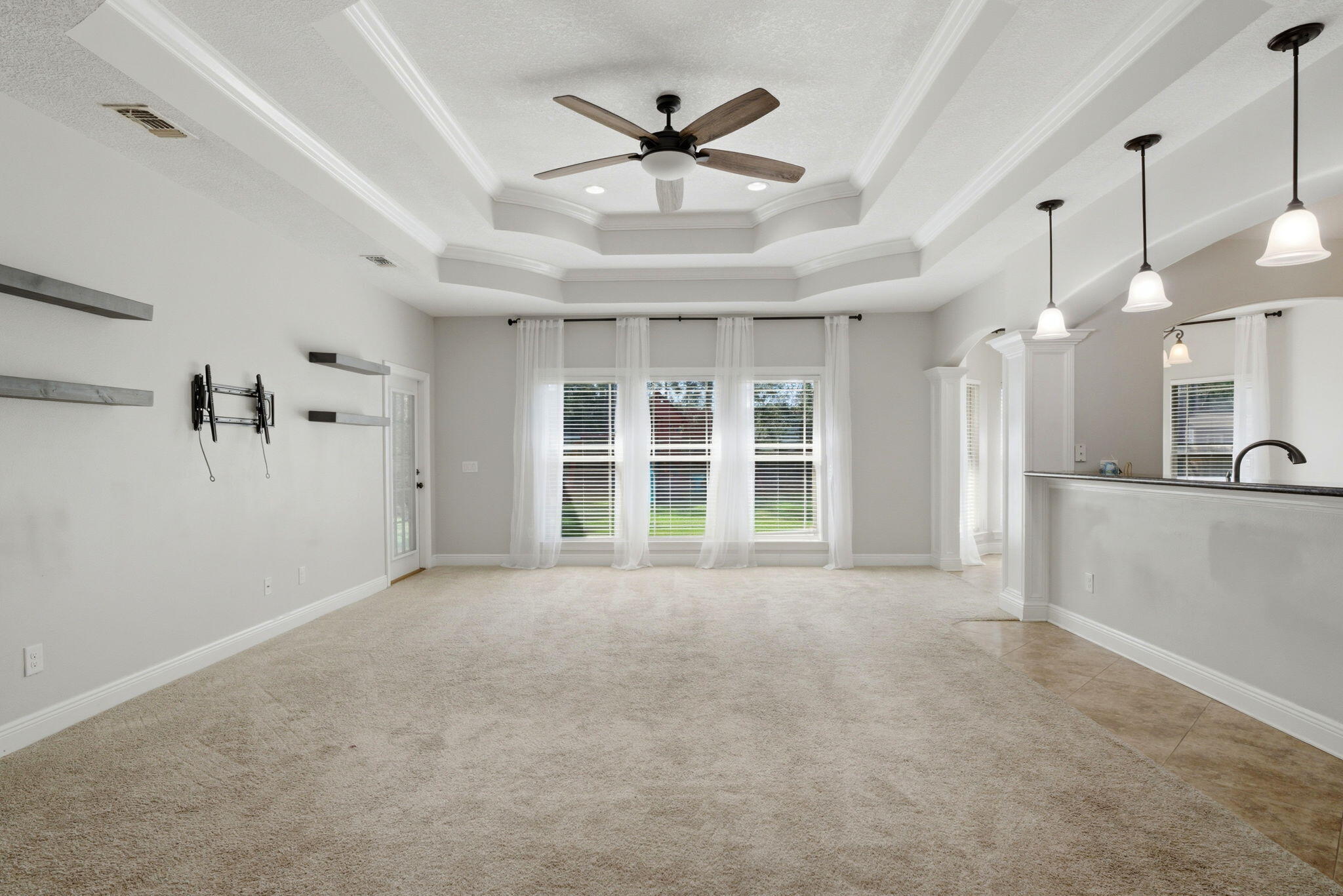 7151 Reef Street Navarre, FL 32566 - Photo 11 of 52 a view of an empty room with a ceiling fan and window