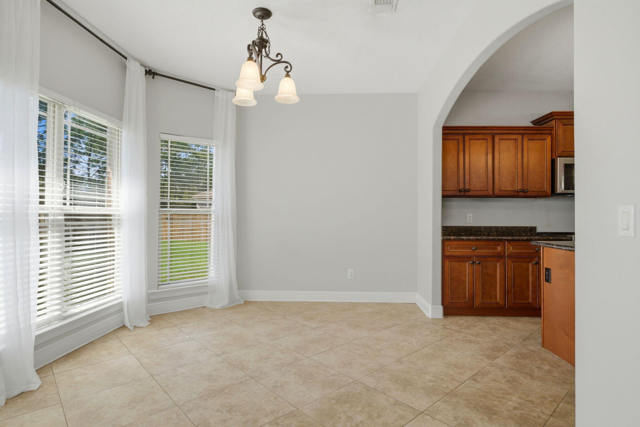 7151 Reef Street Navarre, FL 32566 - Photo 17 of 52 a view of kitchen with granite countertop cabinets and refrigerator