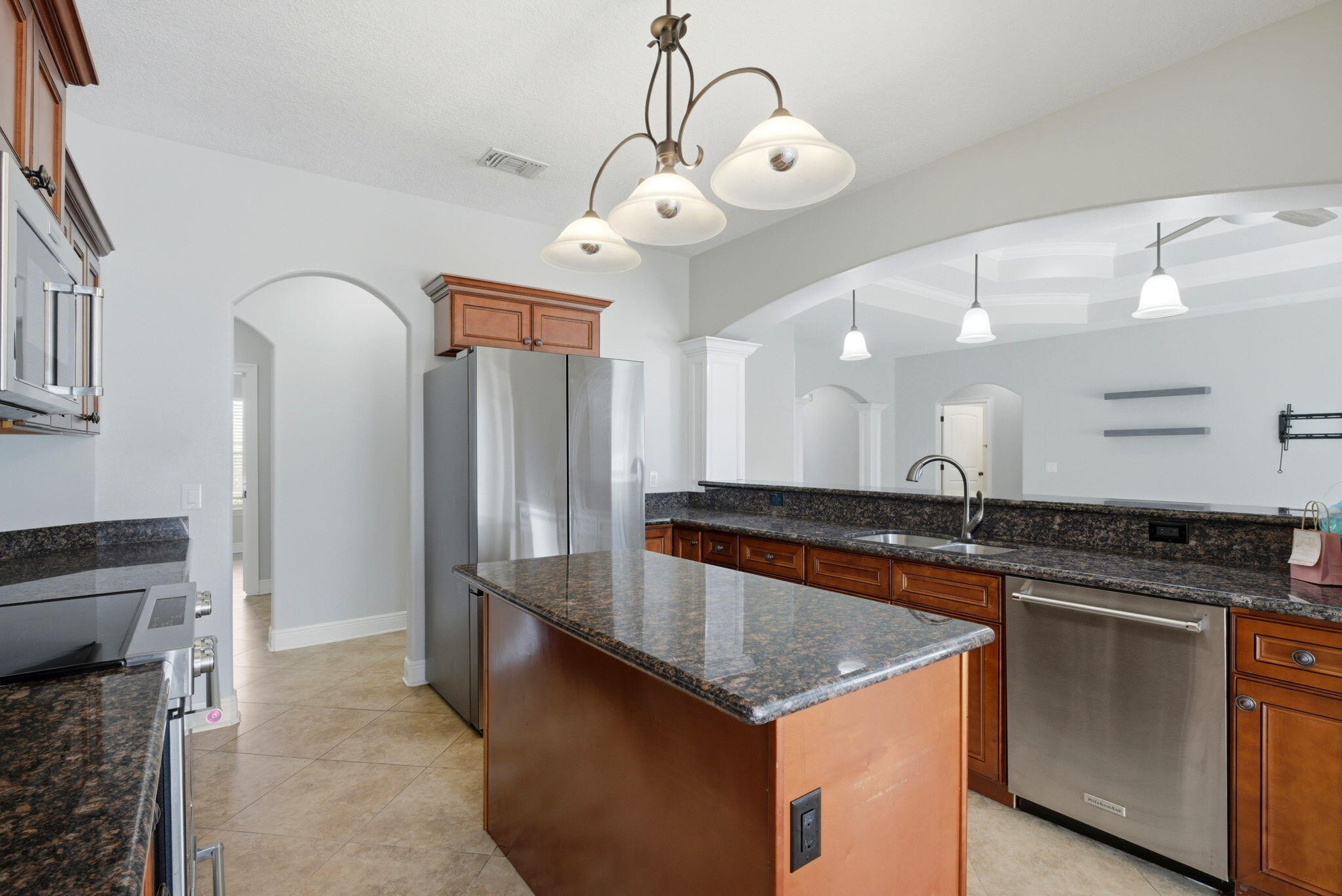 7151 Reef Street Navarre, FL 32566 - Photo 20 of 52 a kitchen with granite countertop a sink and refrigerator