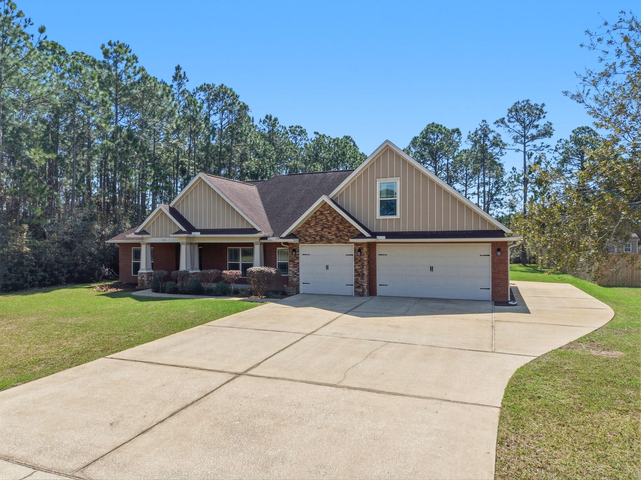 7151 Reef Street Navarre, FL 32566 - Photo 2 of 52 a front view of a house with garden