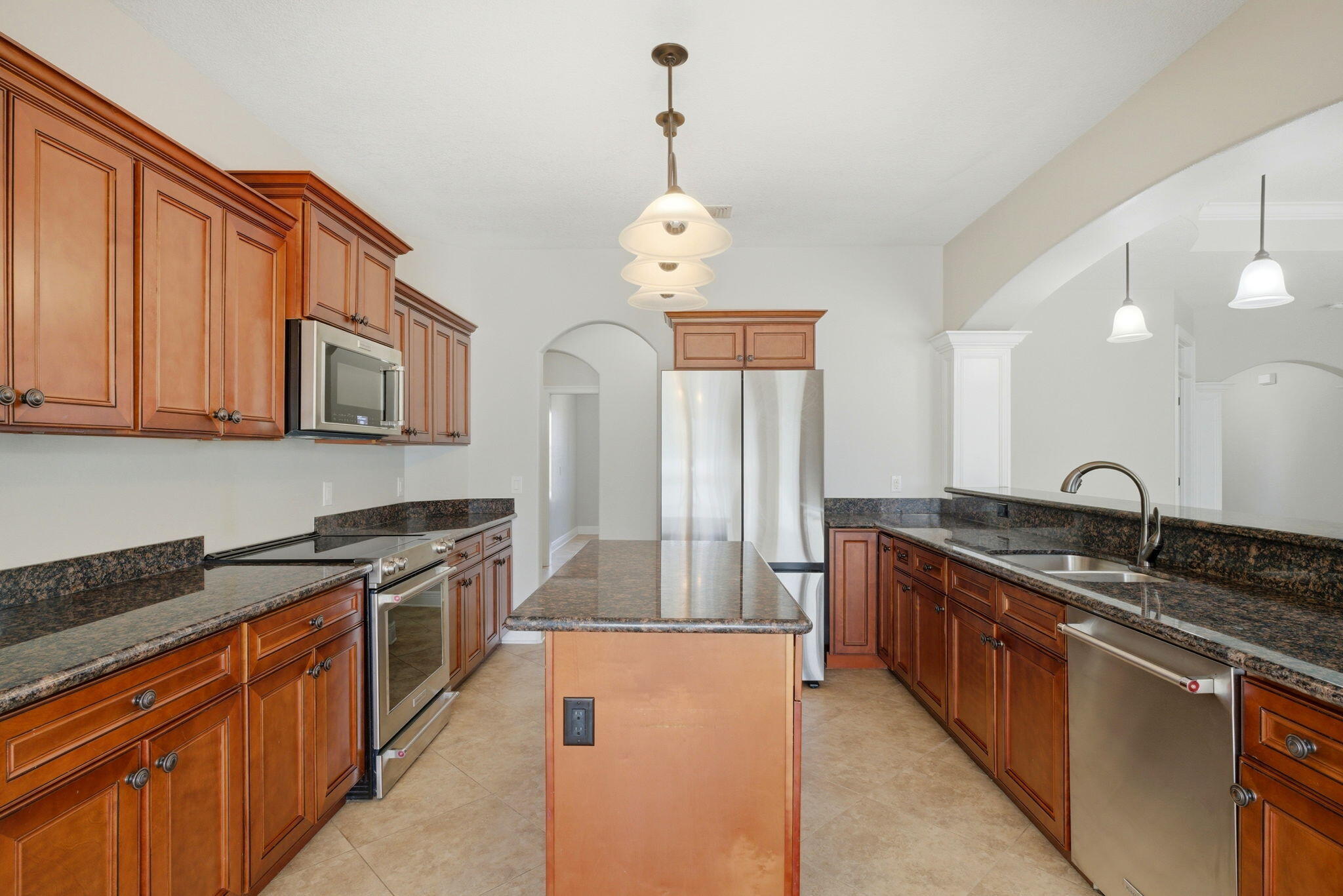 7151 Reef Street Navarre, FL 32566 - Photo 22 of 52 a kitchen with stainless steel appliances granite countertop a stove a sink and a microwave