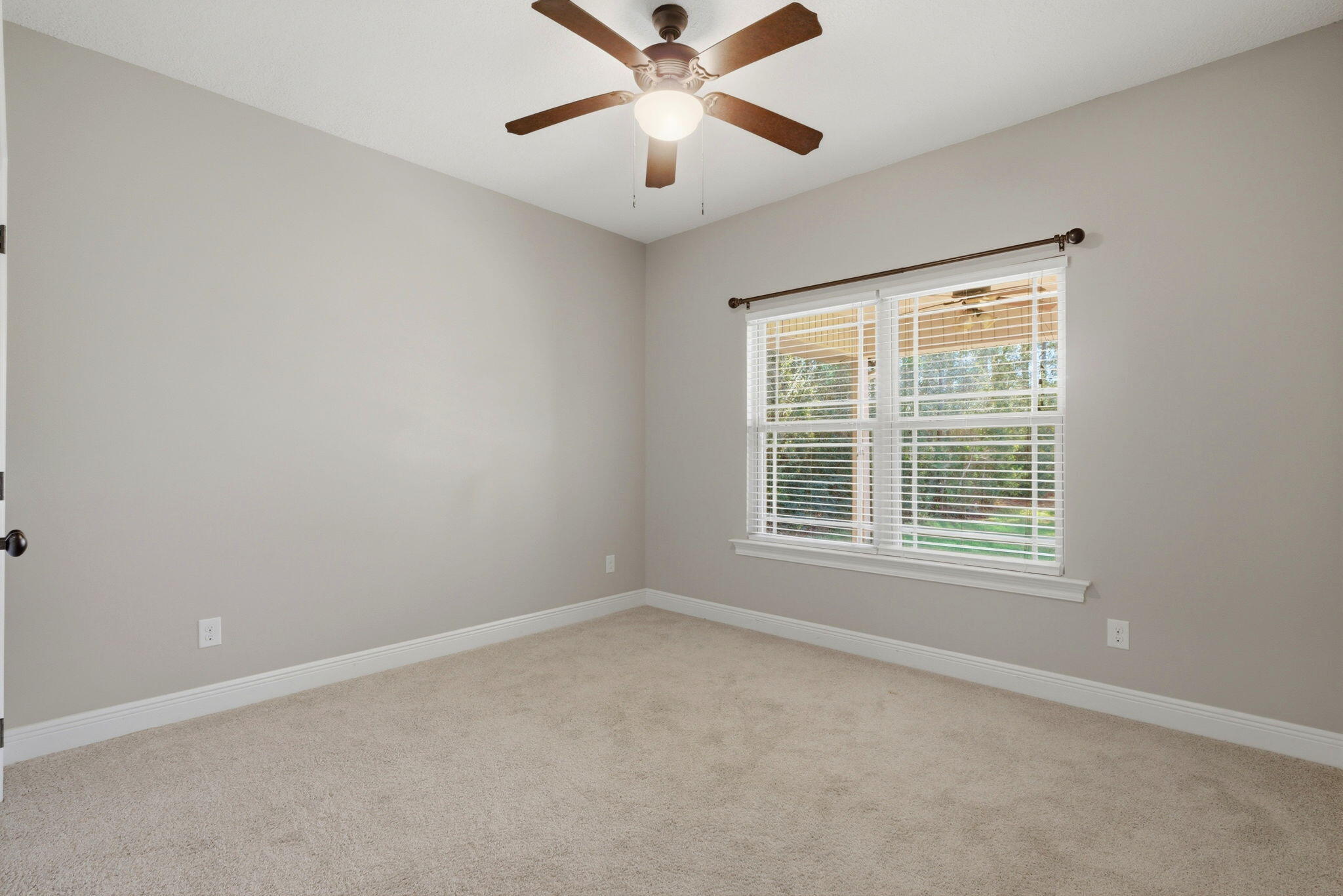 7151 Reef Street Navarre, FL 32566 - Photo 23 of 52 an empty room with a window and a ceiling fan