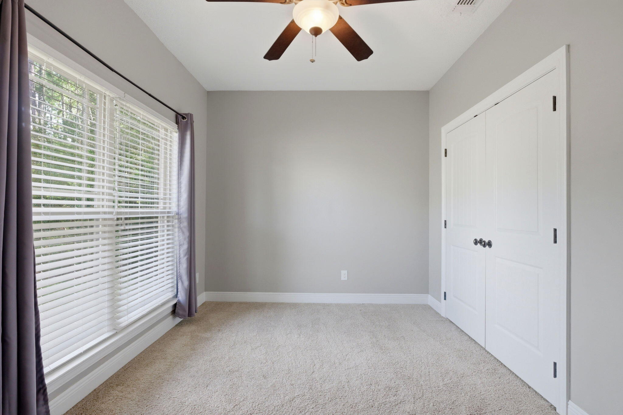 7151 Reef Street Navarre, FL 32566 - Photo 26 of 52 a view of a livingroom with a ceiling fan and window