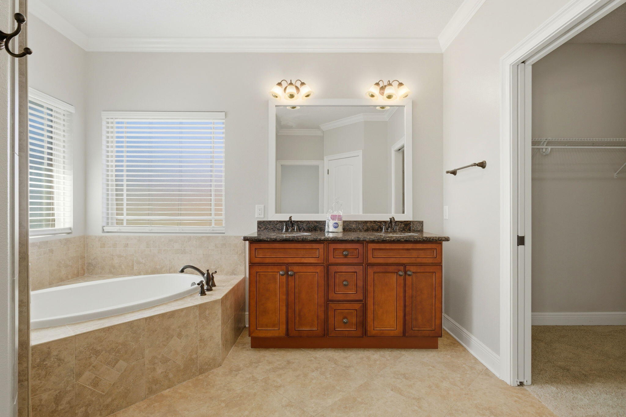 7151 Reef Street Navarre, FL 32566 - Photo 32 of 52 a spacious bathroom with a tub sink and mirror