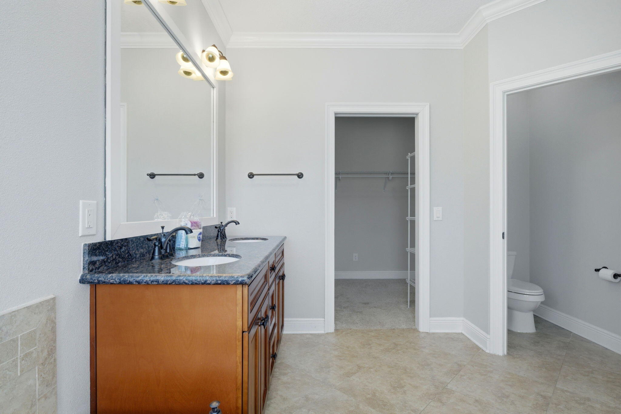 7151 Reef Street Navarre, FL 32566 - Photo 35 of 52 a bathroom with a granite countertop sink and a mirror
