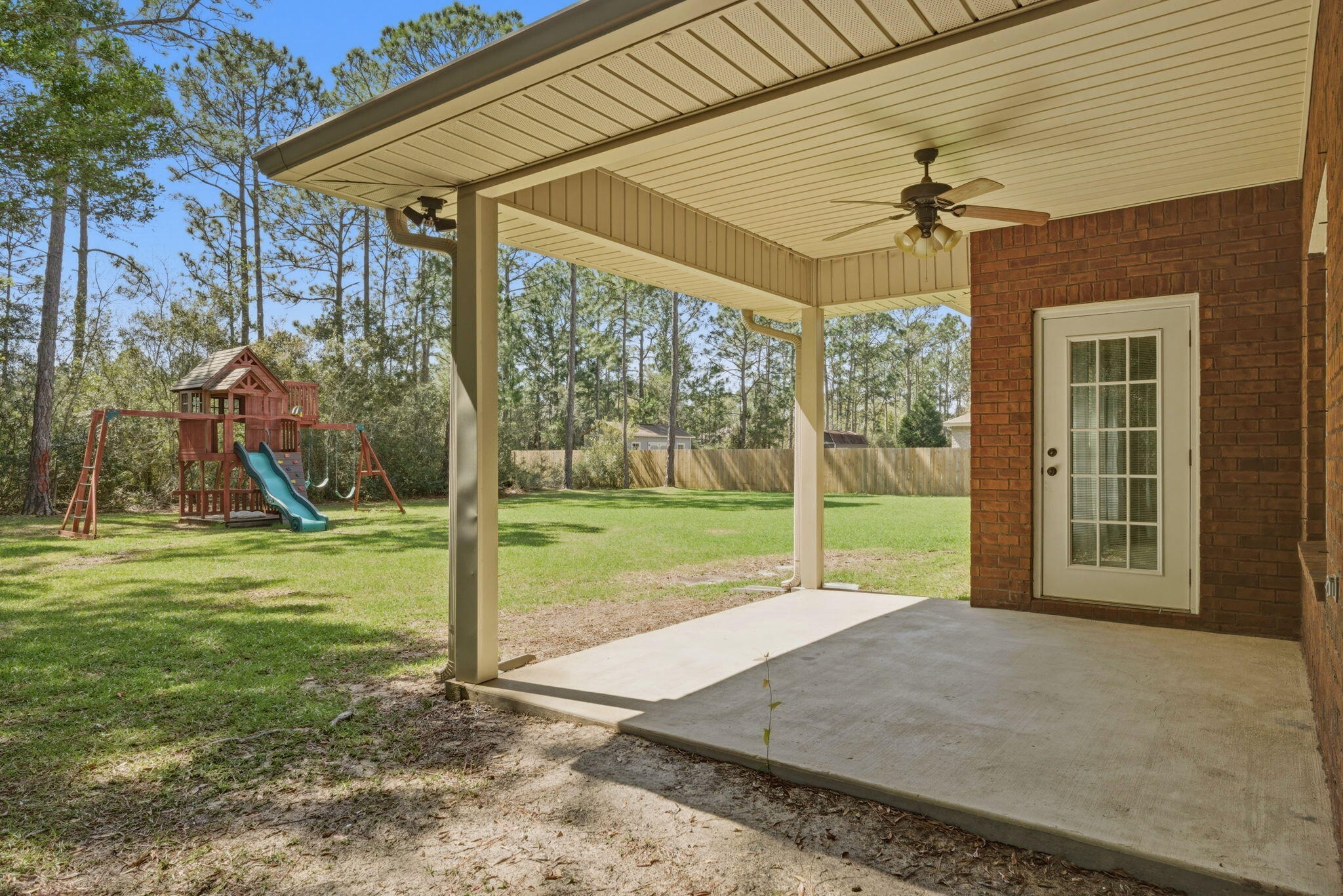 7151 Reef Street Navarre, FL 32566 - Photo 42 of 52 a view of a house with backyard and porch