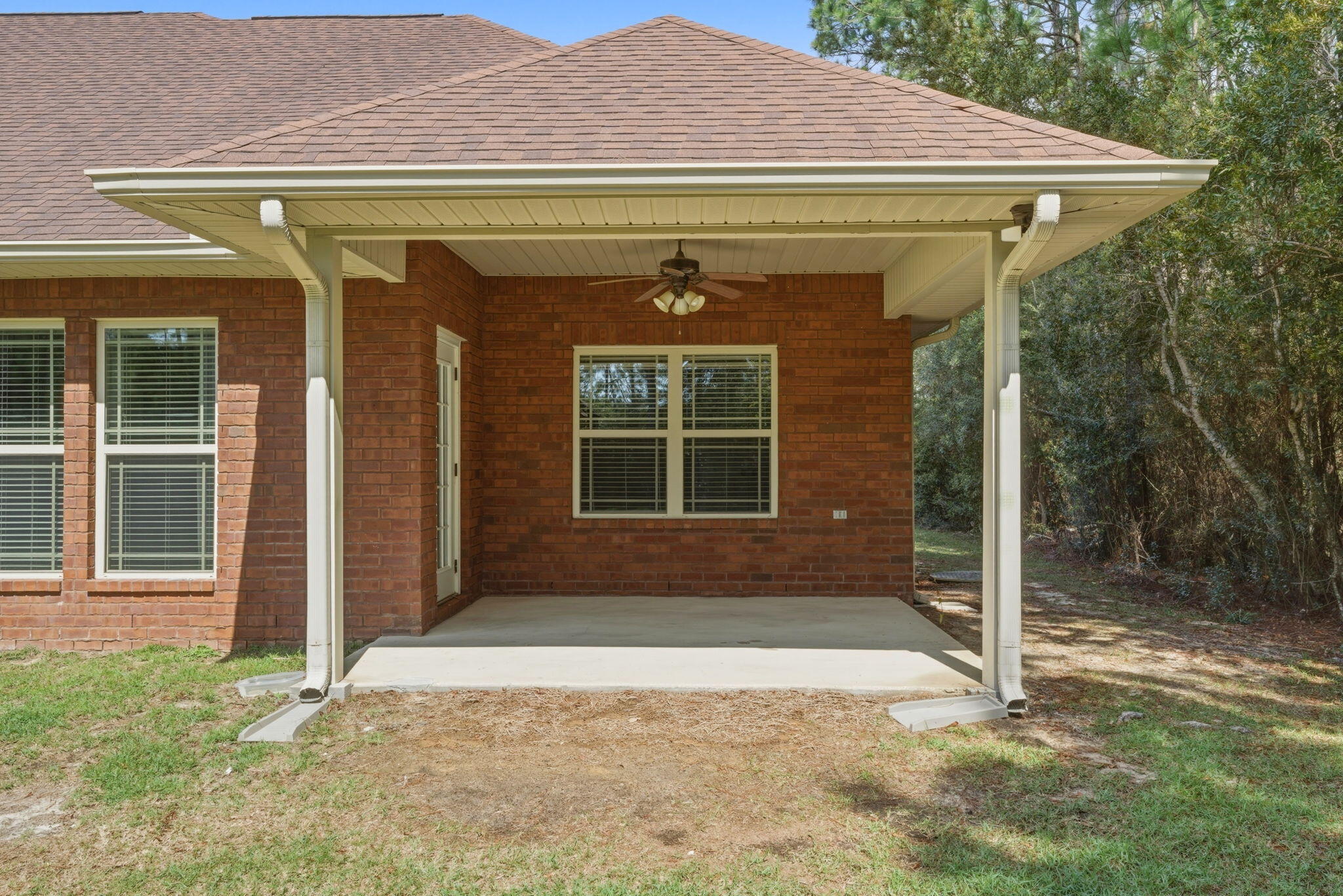 7151 Reef Street Navarre, FL 32566 - Photo 43 of 52 a front view of a house with a yard