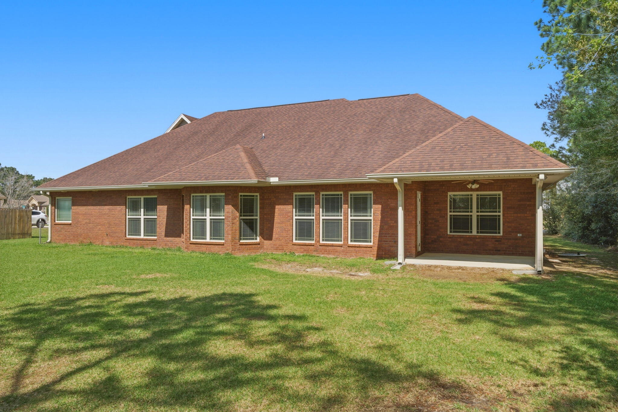 7151 Reef Street Navarre, FL 32566 - Photo 44 of 52 a front view of a house with a garden