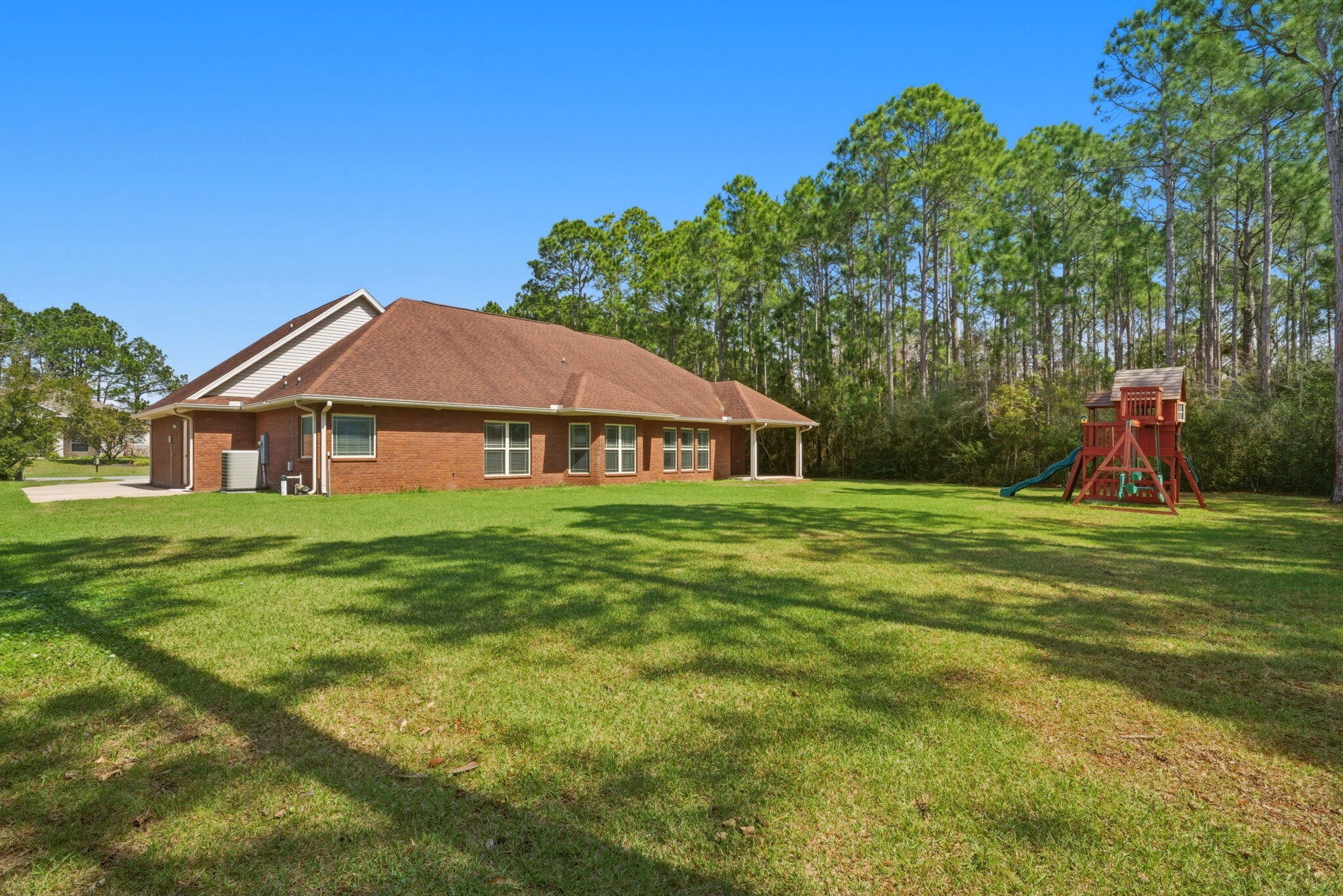 7151 Reef Street Navarre, FL 32566 - Photo 46 of 52 a view of a house with a big yard