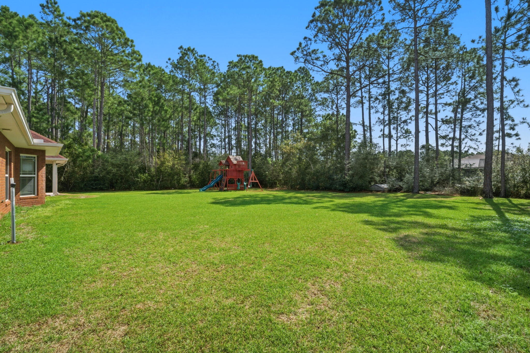 7151 Reef Street Navarre, FL 32566 - Photo 47 of 52 a view of a garden with a slide