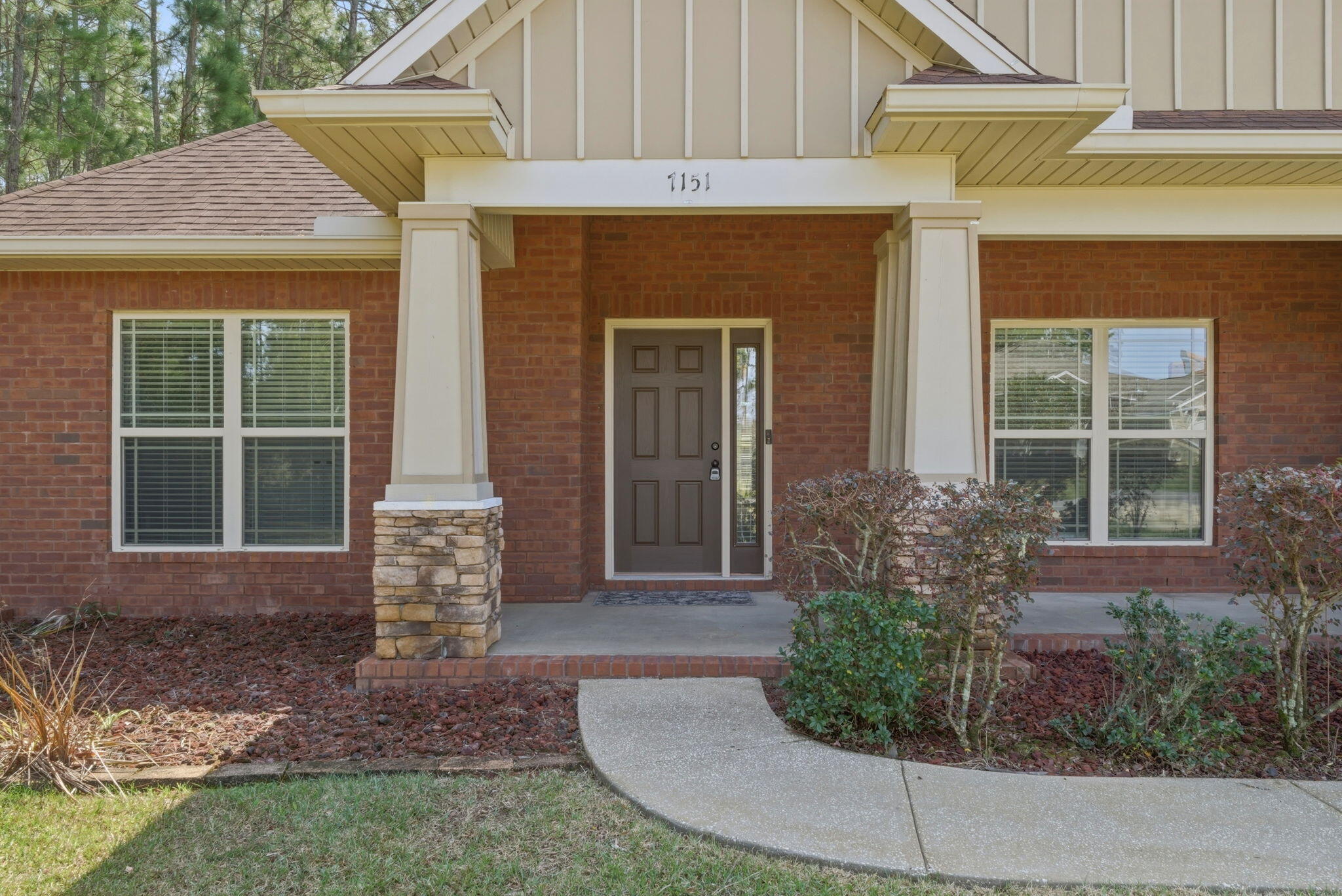 7151 Reef Street Navarre, FL 32566 - Photo 5 of 52 a front view of a house with garden