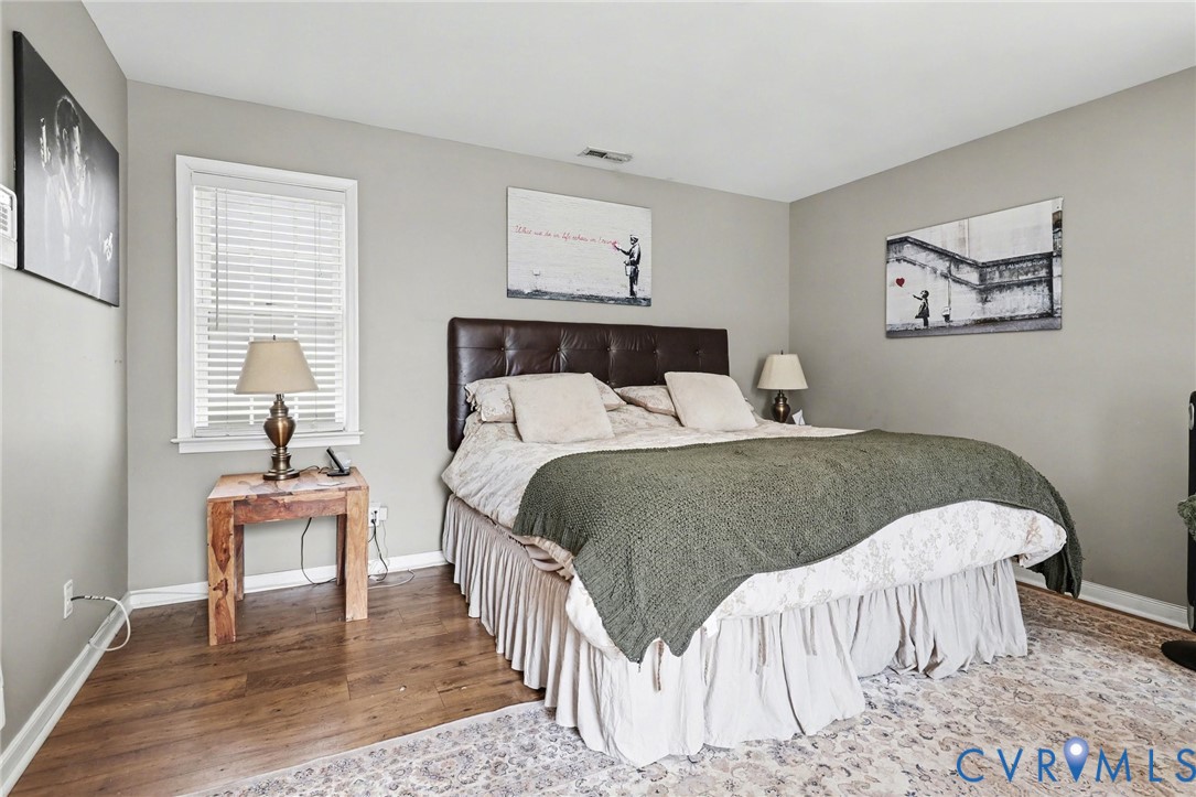 3247 Sherwood Ridge Drive Powhatan, VA 23139 - Photo 15 of 30 a bedroom with a bed and wooden floor