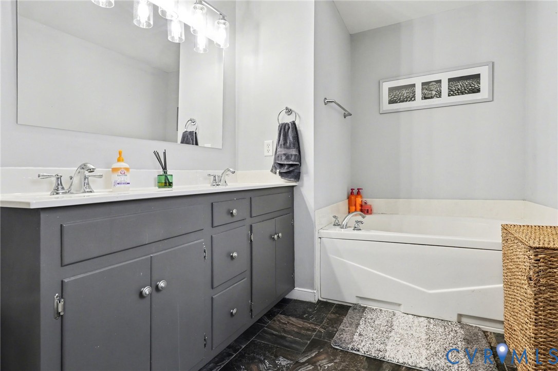 3247 Sherwood Ridge Drive Powhatan, VA 23139 - Photo 17 of 30 a bathroom with a bathtub sink vanity and mirror