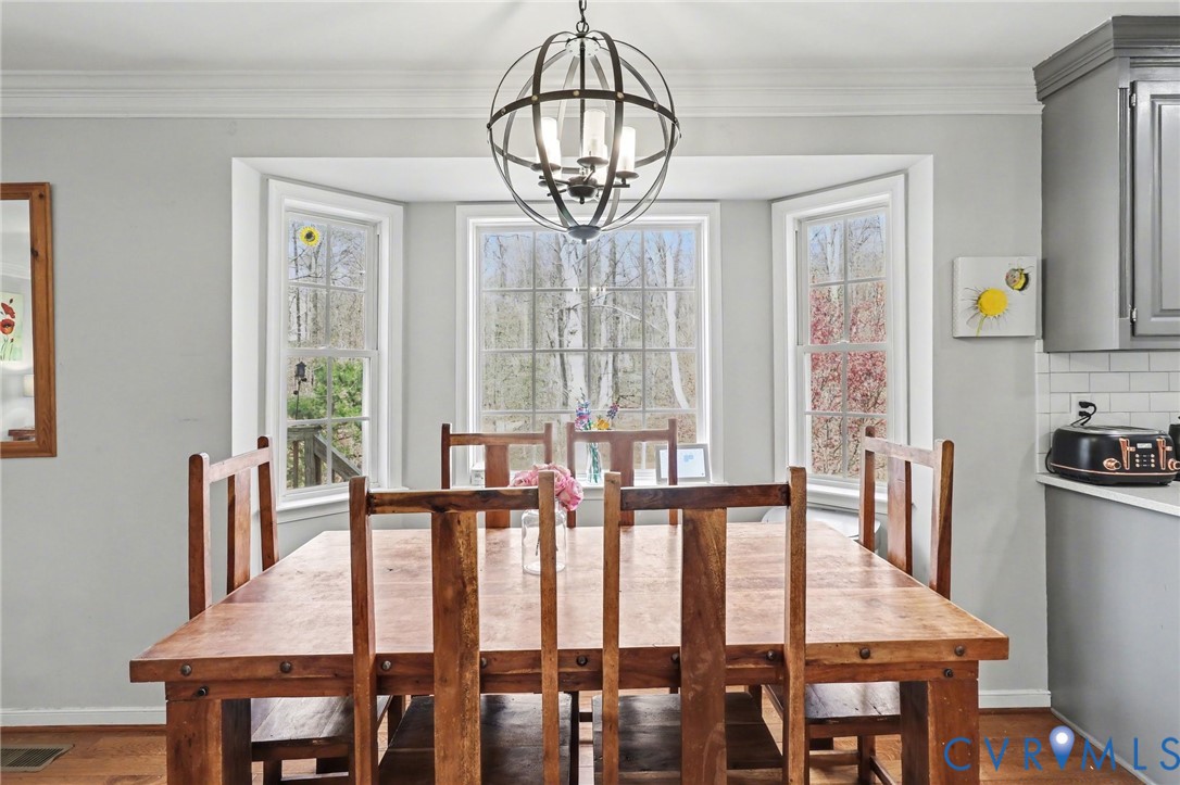 3247 Sherwood Ridge Drive Powhatan, VA 23139 - Photo 6 of 30 a view of a dining room with furniture window and wooden floor