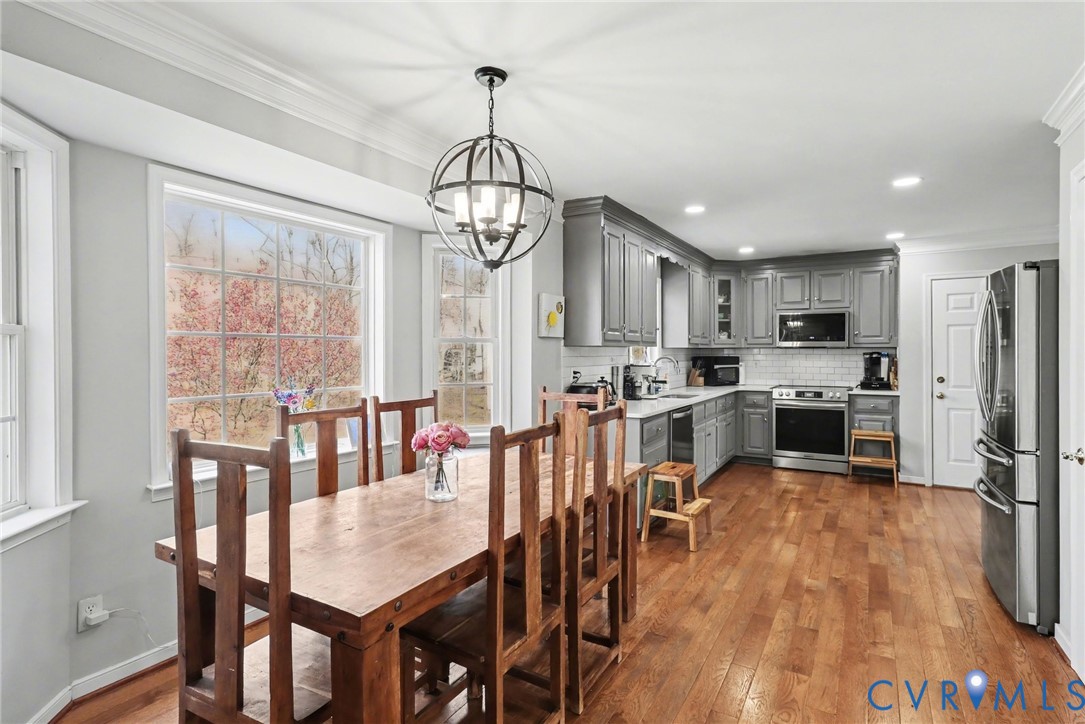 3247 Sherwood Ridge Drive Powhatan, VA 23139 - Photo 7 of 30 a view of a dining room and livingroom with furniture wooden floor clock and a chandelier