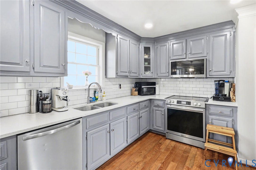 3247 Sherwood Ridge Drive Powhatan, VA 23139 - Photo 8 of 30 a kitchen with stainless steel appliances granite countertop a stove sink and cabinets