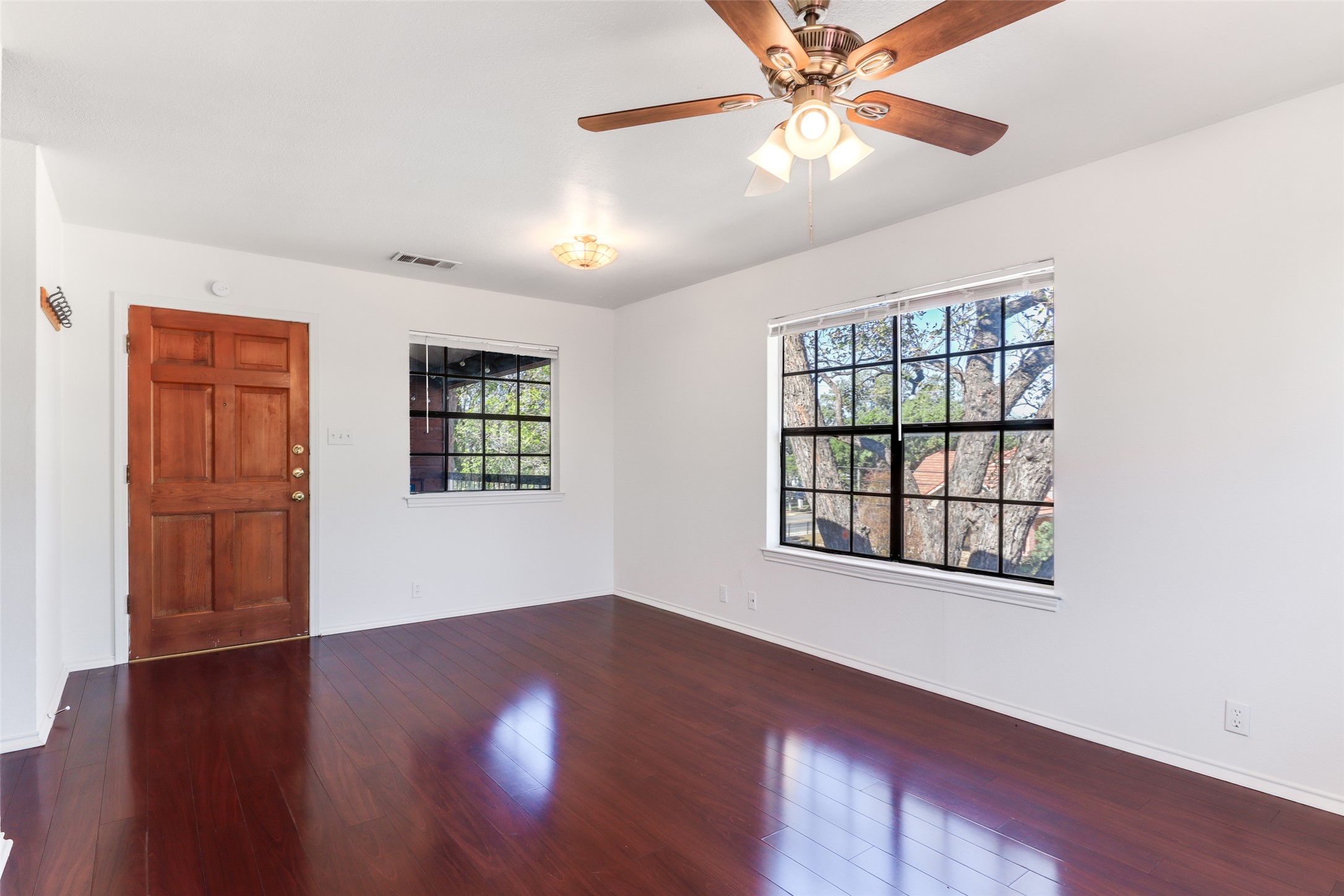 1903 East 20th Street Austin, TX 78722 - Photo 3 of 13 a view of an empty room with window and wooden floor